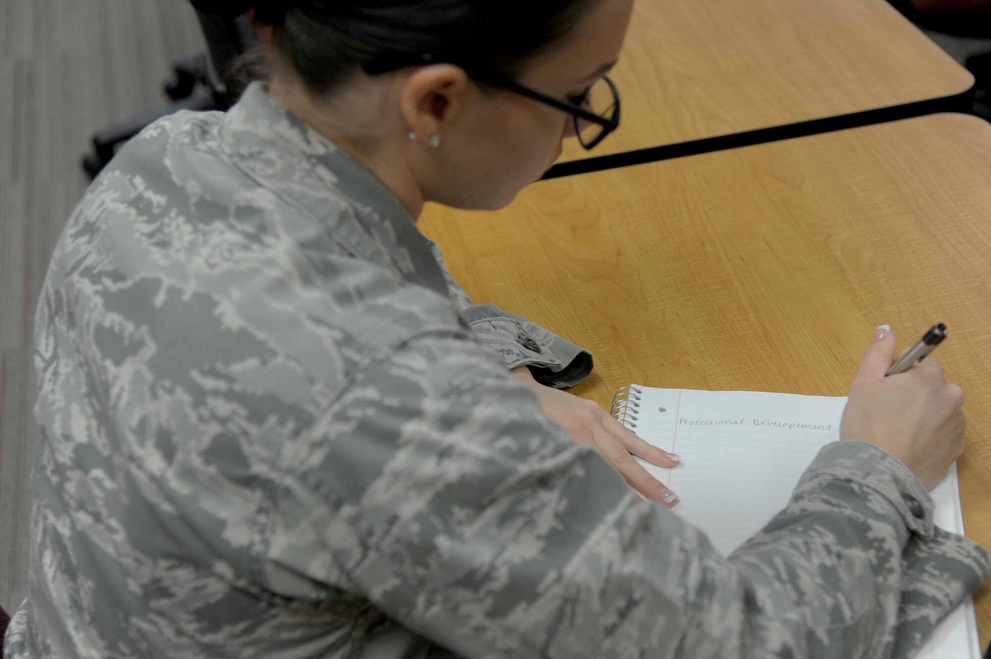 U.S. Air Force Airman Taylor Ross, 17th Security Forces Squadron installation entry controller, takes notes during the Airmen professional development course at the Consolidated Learning Center on Goodfellow Air Force Base, Texas, July 15, 2016. Ross attended the two-day course and learned about retirement, supervisor responsibilities and feedback. (U.S. Air Force photo by Senior Airman Joshua Edwards/Released)