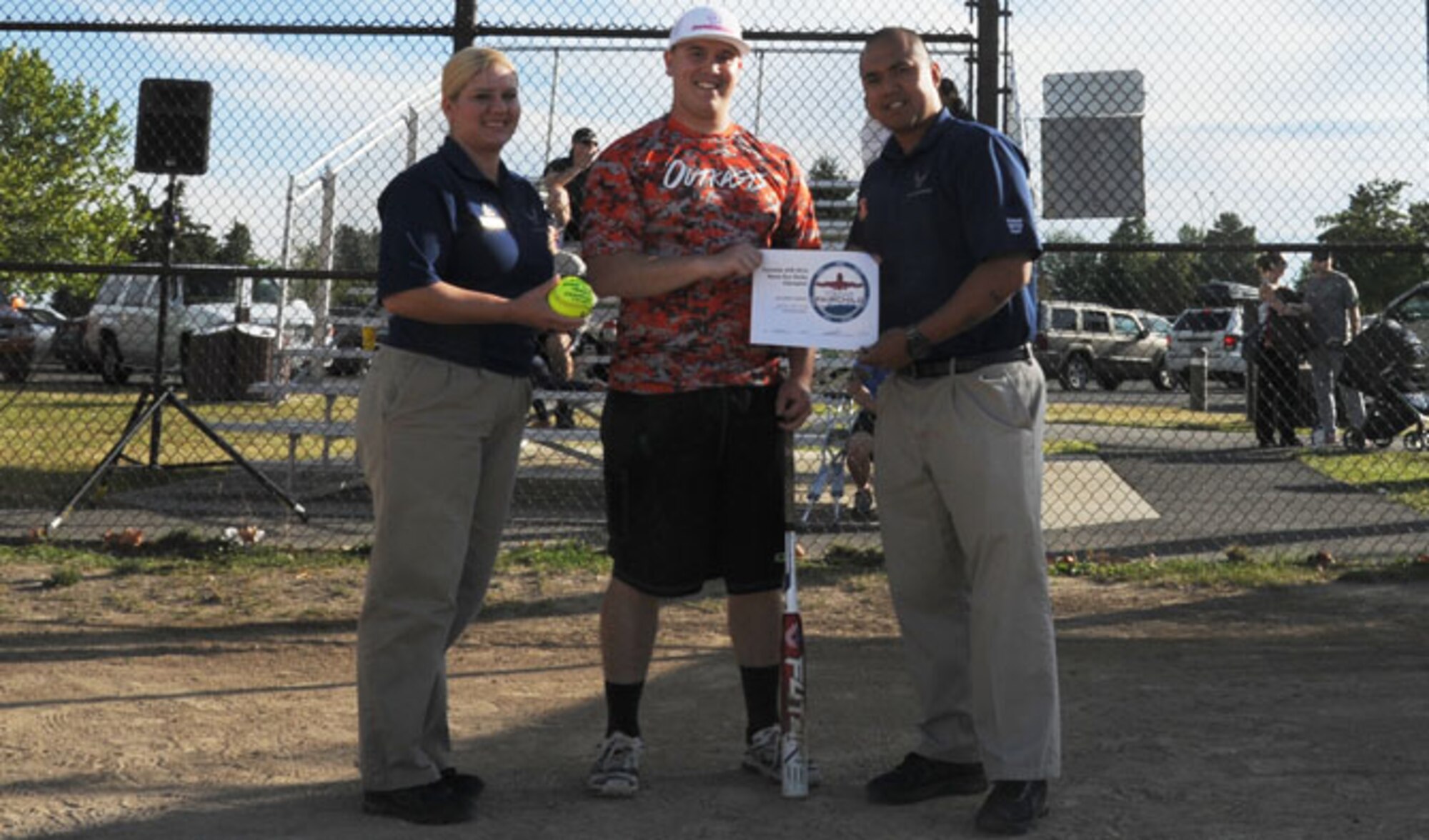 Senior Airman Adam Watford, 92nd Medical Support Squadron pharmacy technician, poses for a photo with Master Sgt. Amy Russell, 92nd Force Support Squadron fitness and sports section chief, and Senior Airman Janmichael Obiniana, 92nd FSS sports program manager, after winning the home run derby July 18, 2016, at Fairchild Air Force Base, Wash. Watford received a souvenir softball and certificate for his accomplishment.