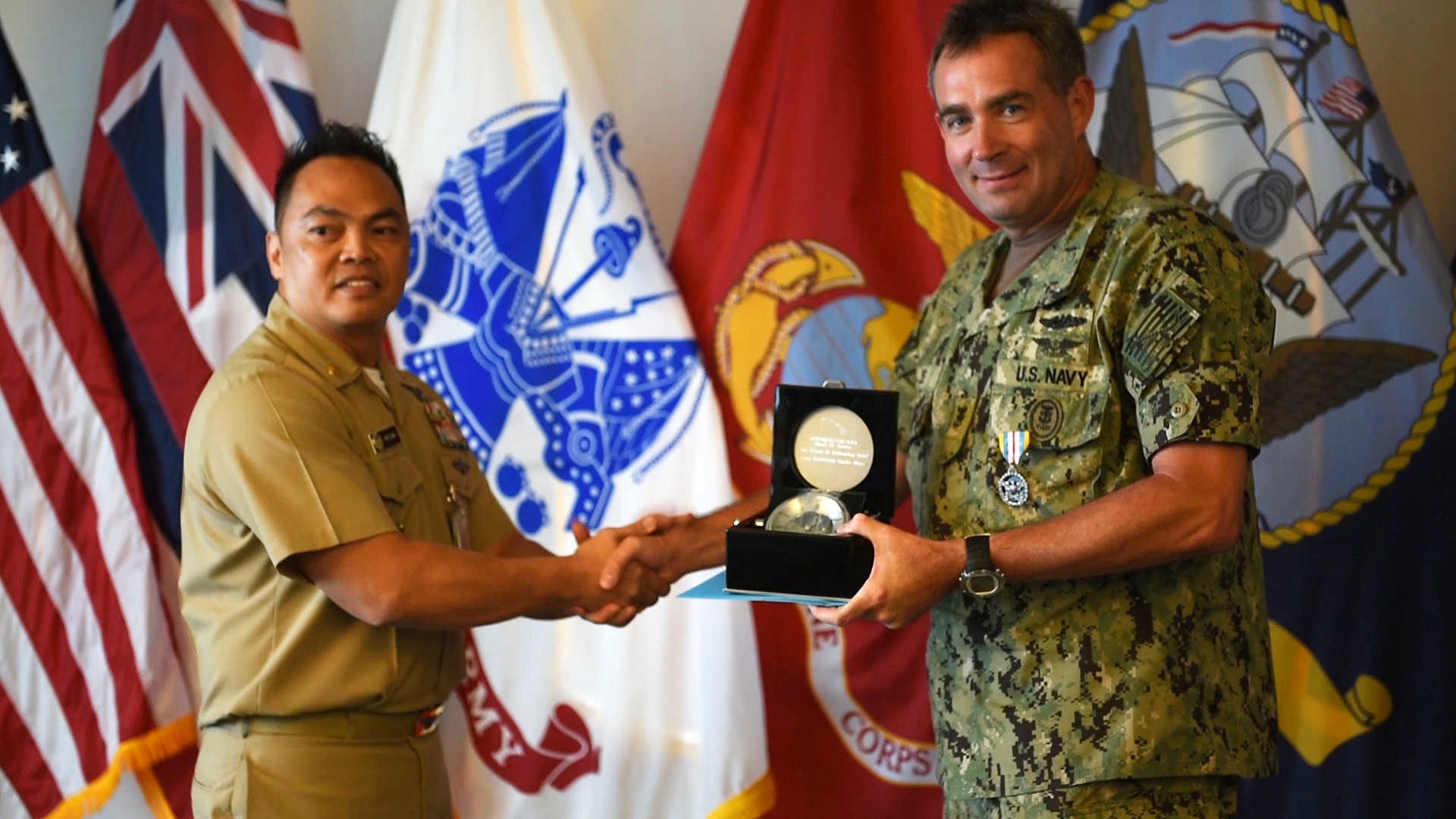 (July 18, 2016) - Fleet Master Chief Mark Rudes, left, U.S. Pacific Command (USPACOM) senior enlisted leader and native of Speculator, N.Y., receives a commemorative compass from Master Chief Culinary Specialist Arturo Luna, USPACOM Navy element command master chief, during an awards ceremony at Camp H. M. Smith, Hawaii June 18. Rudes also received the Defense Superior Service Medal during the ceremony that marked the end of more than four years of service as the USPACOM senior enlisted leader. (DoD photo by Chief Mass Communication Specialist Patrick Dille)