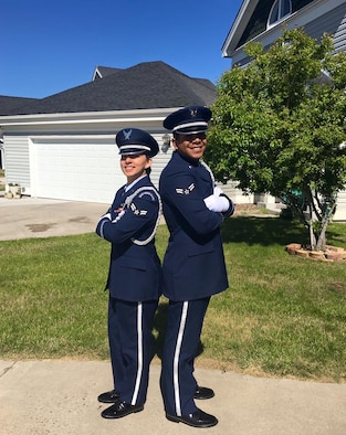Airman 1st Class Alexandra Ayub, 90th Force Support Squadron missile chef, and her husband, Airman 1st Class Ozzie Galvan, 90th FSS fitness specialist, pose in their ceremonial guardsman uniforms outside of their F.E. Warren Air Force Base, Wyo., home. Both Airmen attended technical school together, and both joined the 90th Missile Wing Honor Guard. (Courtesy photo)