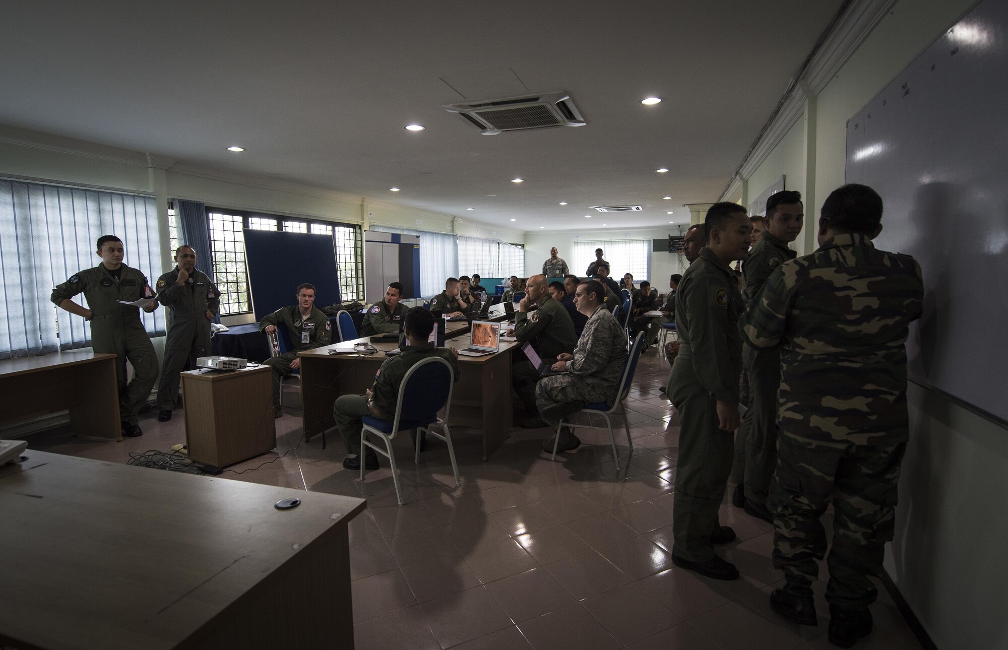 U.S. Air Force and Royal Malaysian Air Force pilots make exercise flight schedules at Cope Taufan 2016 exercise building, at Pangkalan Udara Butterworth Air Base, Malaysia, 18 July 2016. Cope Taufan 16 is a PACAF-led exercise that reinforces U.S. Pacific Command Theater Security Cooperation goals for the Southeast Asian region and demonstrates U.S. capability to project forces strategically in a combined, joint environment.  More than 450 Airmen are participating, as well as four U.S. Air Force airframes. (U.S. Air Force photo by Tech. Sgt. Araceli Alarcon)