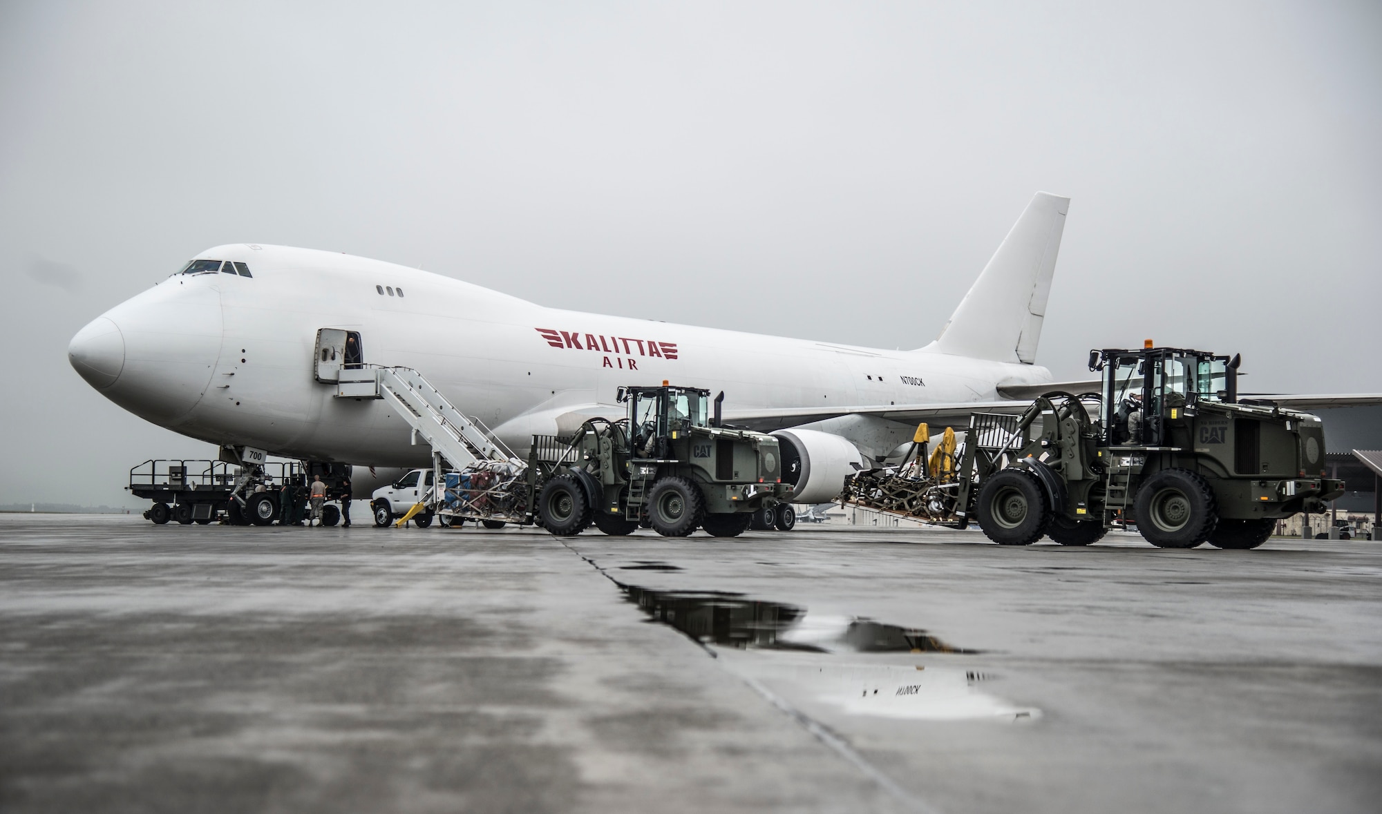 U.S. Air Force Airmen from the 35th Logistics Readiness Squadron operate k-loaders at Misawa Air Base, Japan, July 17, 2016. The Airmen loaded more than 461,000 pounds of cargo destined for Exercise Pitch Black, a three-week multi-national large force employment exercise being conducted from Royal Australian Air Force Base Darwin and RAAF Base Tindal, from July 29 to Aug. 19, 2016. (U.S. Air Force photo by Senior Airman Brittany A. Chase)