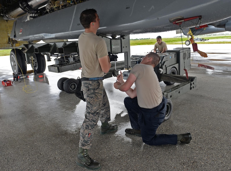 From left, Airman 1st Class Michael O’Donnell, Senior Airman James Rutt, and Senior Airman Ryandolph Alquetra, 36th Expeditionary Aircraft Maintenance Squadron weapons load crew team members, load an inert AGM-86 Conventional Air-Launched Cruise Missiles onto a B-52H Stratofortress during a munitions loading exercise July 13, 2016, at Andersen Air Force Base, Guam. A single B-52H can carry six AGM-86B/C/D missiles on each of two externally mounted pylons and eight internally on a rotary launcher, giving the B-52H a maximum capacity of 20 missiles. (U.S. Air Force photo by Airman 1st Class Alexa Ann Henderson/Released)