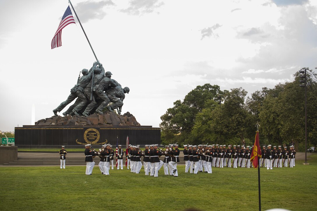 The United States Marine Corps Silent Drill Platoon performs during the Sunset Parade at Arlington, Va., July 19, 2016. The guest of honor for the parade was retired Lt. Col. Jack Matthews and the hosting official was Maj. Gen. John R. Ewers Jr., staff judge advocate to the Commandant of the Marine Corps. (Official Marine Corps photo by Cpl. Chi Nguyen/Released)