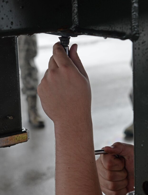 Senior Airman James Rutt, 36th Expeditionary Aircraft Maintenance Squadron weapons load crew team member, uses a speed handle during a munitions loading exercise July 13, 2016, at Andersen Air Force Base, Guam. The exercise tested their ability to quickly and safely load a B-52H Stratofortress with munitions. The ability to properly load an aircraft with munitions is integral to provide combat-ready aircraft in support of U.S. Pacific Command’s continuous bomber presence mission. (U.S. Air Force photo by Airman 1st Class Alexa Ann Henderson/Released)