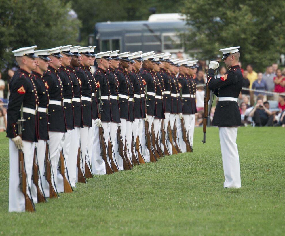 The United States Marine Corps Silent Drill Platoon performs during the Sunset Parade at Arlington, Va., July 19, 2016. The guest of honor for the parade was retired Lt. Col. Jack Matthews and the hosting official was Maj. Gen. John R. Ewers Jr., staff judge advocate to the Commandant of the Marine Corps. (Official Marine Corps photo by Lance Cpl. Robert Knapp/Released)