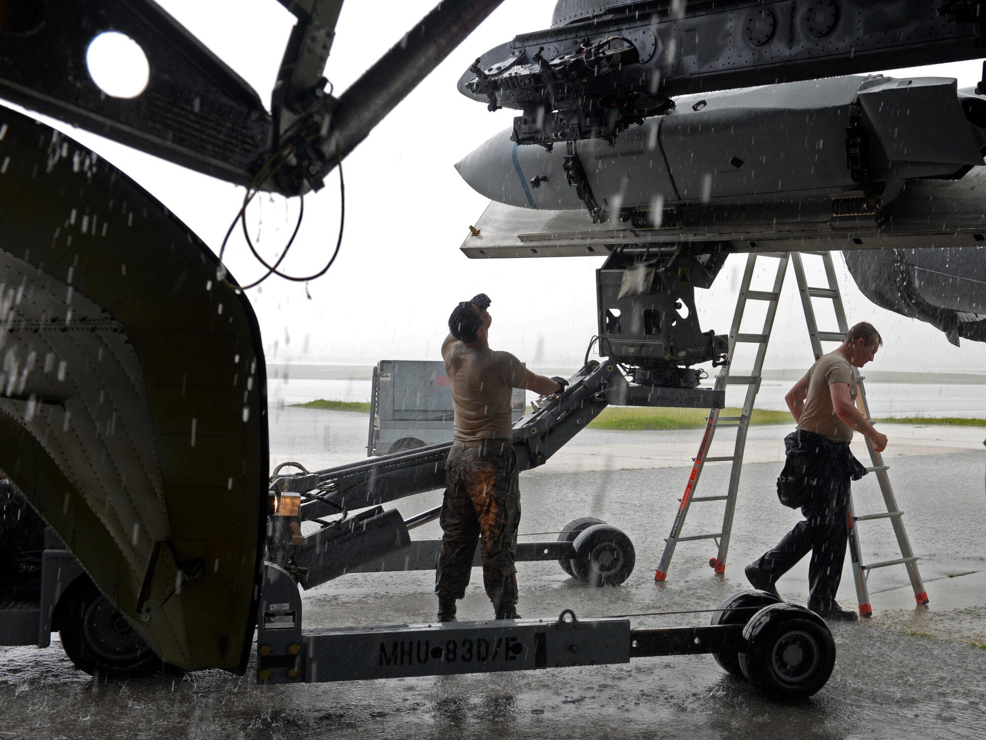 Airman 1st Class Michael O’Donnell, left, Senior Airman James Rutt, 36th Expeditionary Aircraft Maintenance Squadron weapons load crew team members, load an inert AGM-158 Joint Air-to-Surface Standoff Missile onto a B-52H Stratofortress during a munitions loading exercise July 13, 2016, at Andersen Air Force Base, Guam. The exercise tested their ability to quickly and safely load a B-52H with munitions, which is integral to provide combat-ready aircraft in support of U.S. Pacific Command’s continuous bomber presence mission. (U.S. Air Force photo by Airman 1st Class Alexa Ann Henderson/Released)