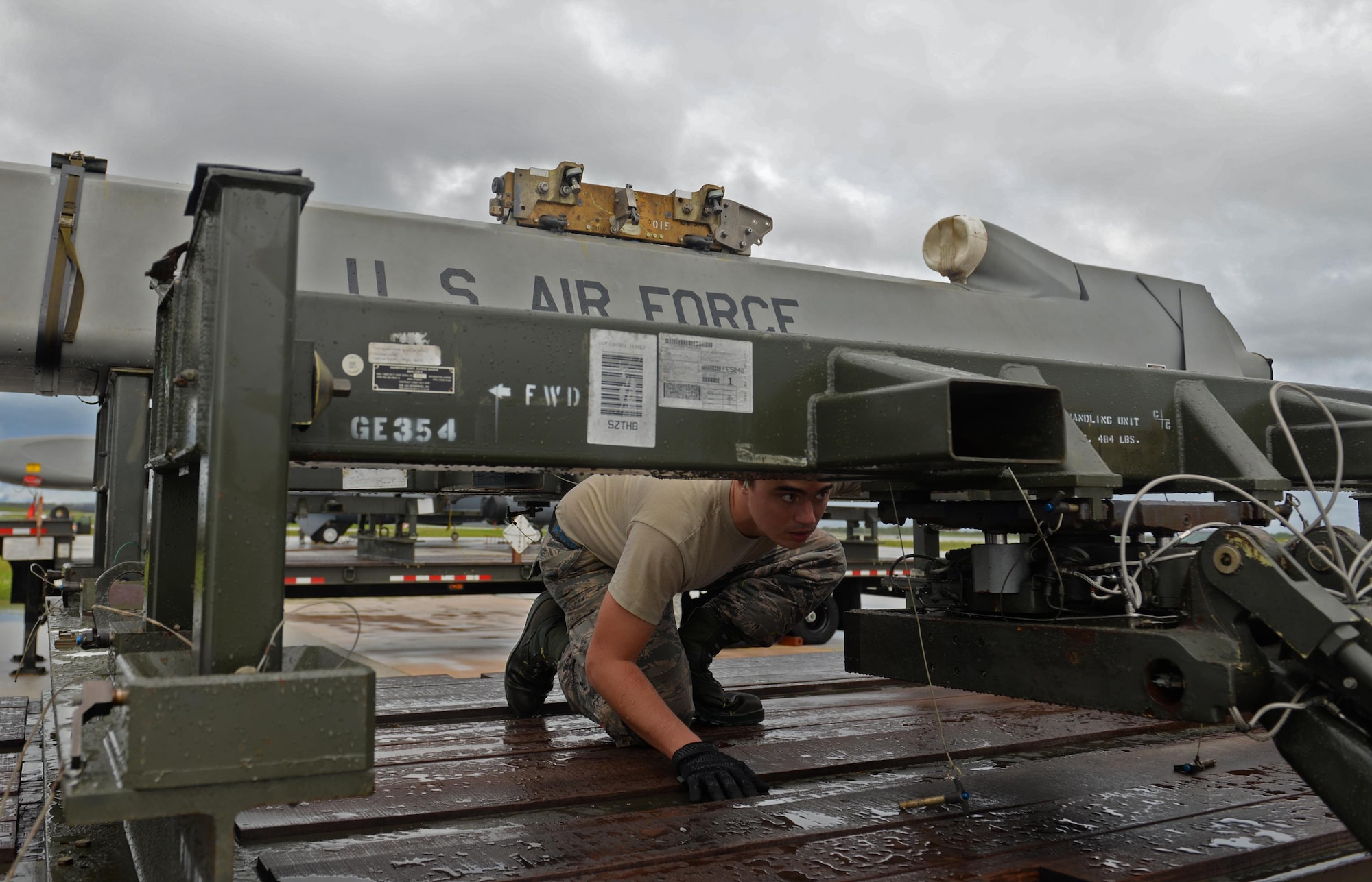 Airman 1st Class Michael O’Donnell, 36th  Expeditionary Aircraft Maintenance Squadron weapons load crew team member, checks the connection between an inert AGM-86 Conventional Air Launched Cruise Missile and a MHU-83 bomb lift truck during a munitions loading exercise July 13, 2016, at Andersen Air Force Base, Guam. Airmen practiced loading an entire B-52 Stratofortress with 12 AGM-158 Joint Air-to-Surface Standoff Missiles and eight AGM-158 Joint Air-to-Surface Standoff Missiles. (U.S. Air Force photo by Airman 1st Class Alexa Ann Henderson/Released)