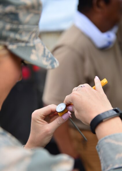 Airman 1st Class Jessika Willis, 15th Aerospace Medicine Squadron public heath technician, checks the ambient temperature of a food transport truck on Joint Base Pearl Harbor-Hickam, July 15, 2016. Airmen from the 15th Aerospace Medicine Squadron are working alongside Soldiers from the Public Heath Command District Central Pacific Hawaii to ensure food is safely delivered to service members aboard 33 military vessels during the Rim of the Pacific Exercise 2016. Twenty-six nations, more than 40 ships and submarines, 200 aircraft, and 25,000 personnel are participating in RIMPAC from June 30 to Aug. 4, in and around the Hawaiian Islands and Southern California. The world's largest international maritime exercise, RIMPAC provides a unique training opportunity that helps participants foster and sustain the cooperative relationships that are critical to ensuring the safety of sea lanes and security on the world's oceans.  (U.S. Air Force photo by Tech. Sgt. Aaron Oelrich/Released)   