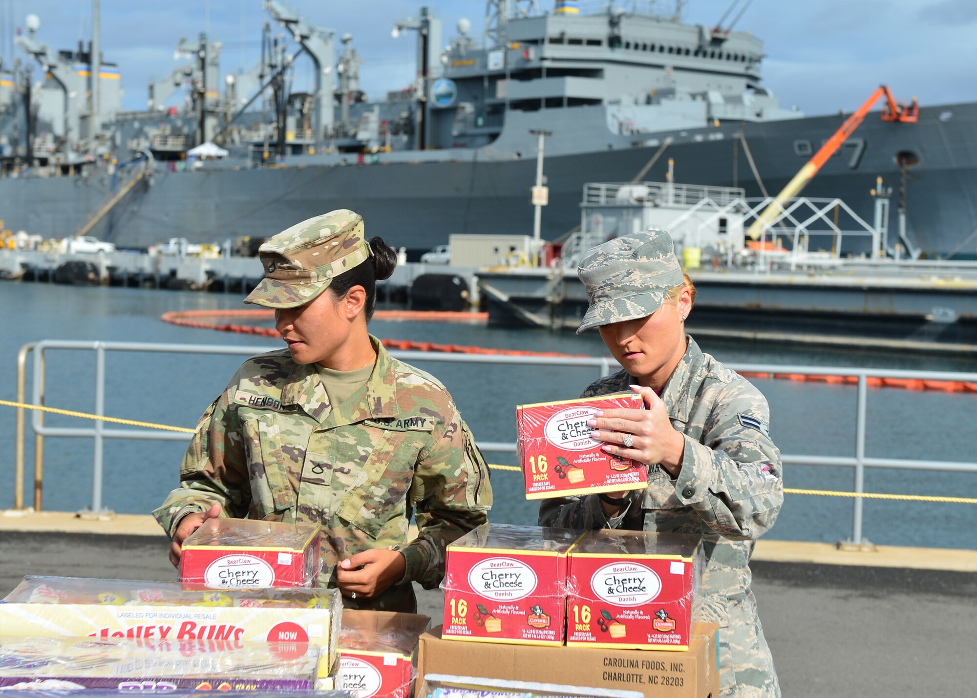 Army Pfc. Marissa Henson, Public Heath Command District Central Pacific Hawaii food inspector, and Airman 1st Class Jessika Willis, 15th Aerospace Medicine Squadron public heath technician, inspect a pallet of food prior to delivery to the USS John C. Stennis (CVN-74) on Joint Base Pearl Harbor-Hickam, July 15 2016. Airmen from the 15th Aerospace Medicine Squadron are working alongside Soldiers from the Public Heath Command District Central Pacific Hawaii to ensure food is safely delivered to service members aboard 33 military vessels during the Rim of the Pacific Exercise 2016. Twenty-six nations, more than 40 ships and submarines, more than 200 aircraft, and 25,000 personnel are participating in RIMPAC from June 30 to Aug. 4, in and around the Hawaiian Islands and Southern California. The world's largest international maritime exercise, RIMPAC provides a unique training opportunity that helps participants foster and sustain the cooperative relationships that are critical to ensuring the safety of sea lanes and security on the world's oceans. (U.S. Air Force photo by Tech. Sgt. Aaron Oelrich/Released)   