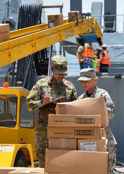 Airman 1st Class Jessika Willis, 15th Aerospace Medicine Squadron public heath technician, checks the ambient temperature of a food transport truck on Joint Base Pearl Harbor-Hickam, July 15, 2016. Airmen from the 15th Aerospace Medicine Squadron are working alongside Soldiers from the Public Heath Command District Central Pacific Hawaii to ensure food is safely delivered to service members aboard 33 military vessels during the Rim of the Pacific Exercise 2016. Twenty-six nations, more than 40 ships and submarines, 200 aircraft, and 25,000 personnel are participating in RIMPAC from June 30 to Aug. 4, in and around the Hawaiian Islands and Southern California. The world's largest international maritime exercise, RIMPAC provides a unique training opportunity that helps participants foster and sustain the cooperative relationships that are critical to ensuring the safety of sea lanes and security on the world's oceans.  (U.S. Air Force photo by Tech. Sgt. Aaron Oelrich/Released)   