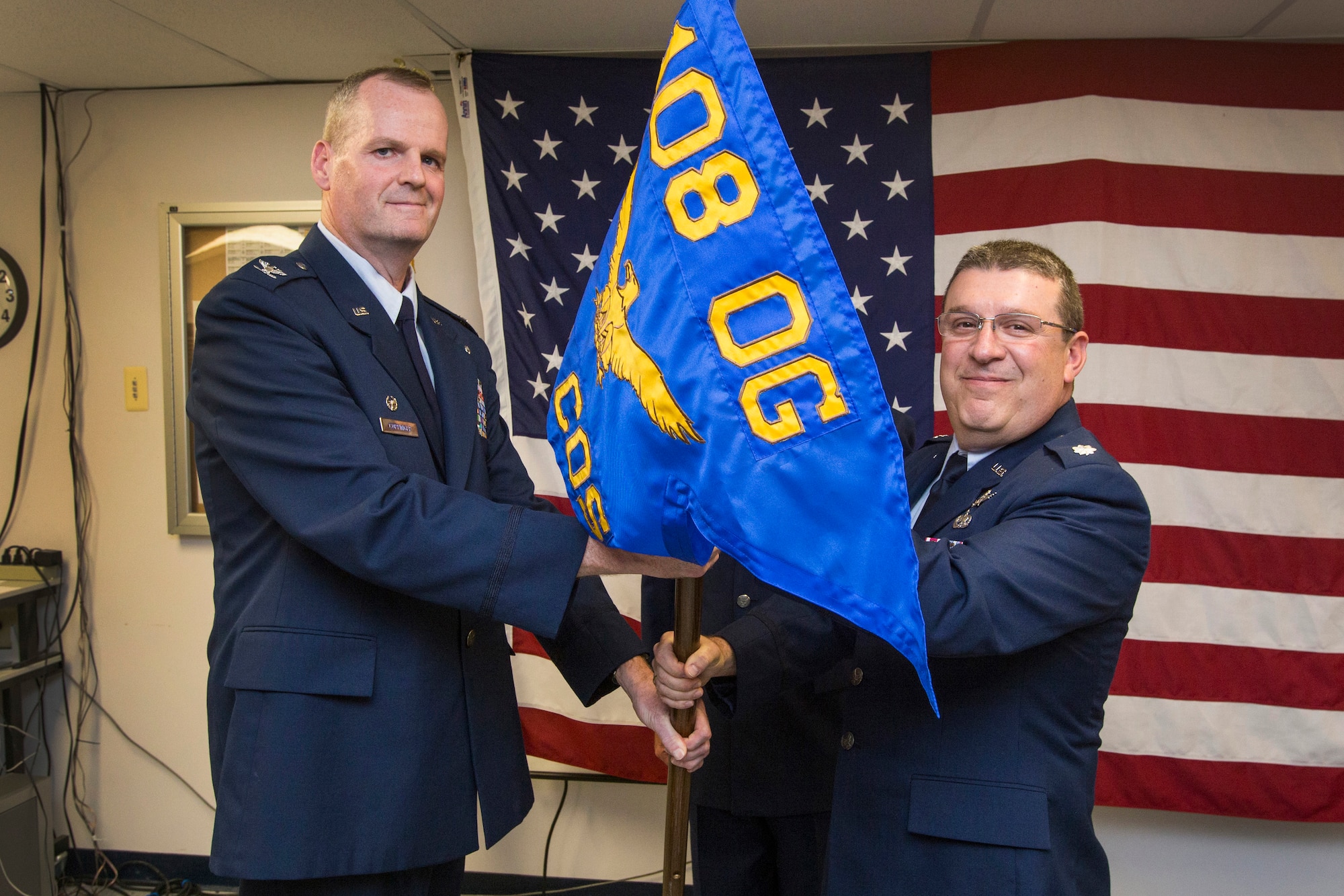 Lt. Col. Anthony Zissimos, right, accepts the 108th Operations Group guidon from Col. Thomas L. Coppinger, commander, 108th Wing Operations Group, New Jersey Air National Guard, assuming command of the 140th Cyber Operations Squadron at Joint Base McGuire-Dix-Lakehurst, N.J., July 17, 2016. Zissimos became the commander of the New Jersey Air National Guard’s newest squadron, which is charged with monitoring cyber-attacks to the nation’s computer networks, stopping the attacks, identifying the hackers, and repairing the damage. (U.S. Air National Guard photo by Master Sgt. Mark C. Olsen/Released)