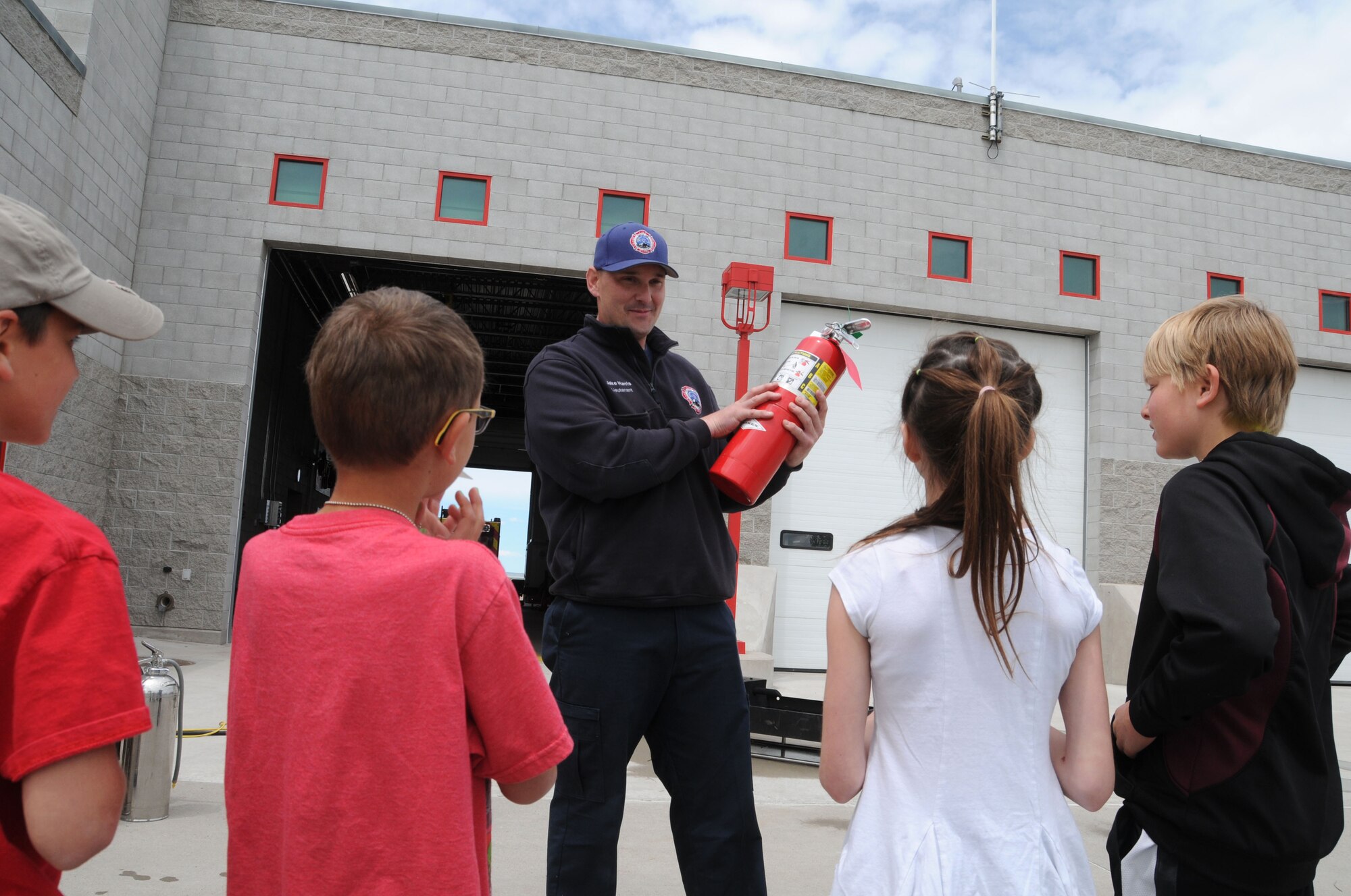 Montana Air National Guard Fire Department Lt. Jacob Harris demonstrates how to operate a fire extinguisher during a STARBASE tour of the station June 15, 2016. (U.S. Air National Guard photo/Senior Master Sgt. Eric Peterson)