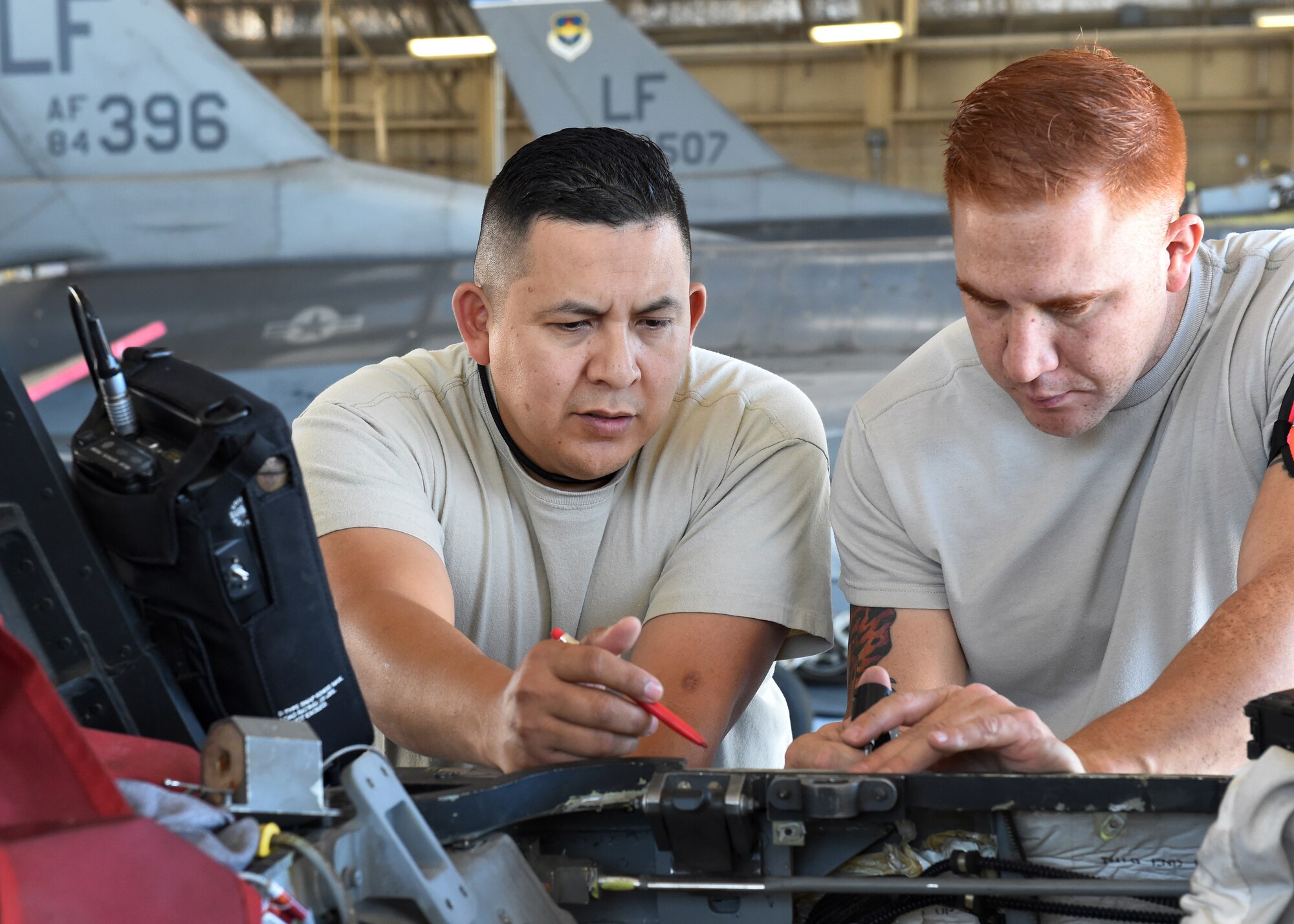 Master Sgt. Charles Ramirez and Tech. Sgt. Eric Garza, non-destructive inspection technicians, inspect an F-16D Fighting Falcon's longeron in the aircraft’s canopy sill at Luke Air Force Base, Ariz., April 12, 2016. Ramirez and Garza are members of the Texas Air National Guard’s 149th Fighter Wing, headquartered at Joint Base San Antonio-Lackland, Texas. (U.S. Air National Guard photo by 2nd Lt. Phil Fountain)