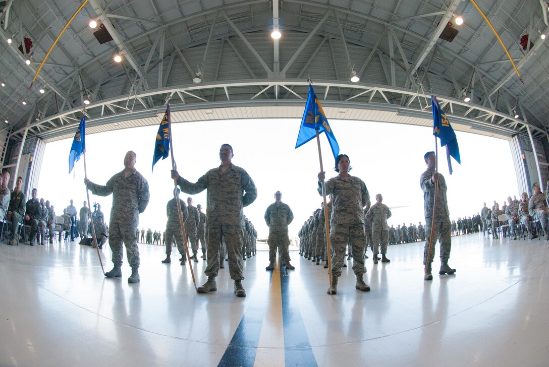 Airmen from the 154th Wing stand at parade rest during the wing's change of command ceremony on Joint Base Pearl Harbor-Hickam, July 10, 2016. The formation consists of airmen from each of the four groups within the 154th Wing; Medical Group, Maintenance Group, Mission Support Group and Operations Group. (U.S. Air National Guard photo by Airman 1st Class Robert Cabuco/released) 