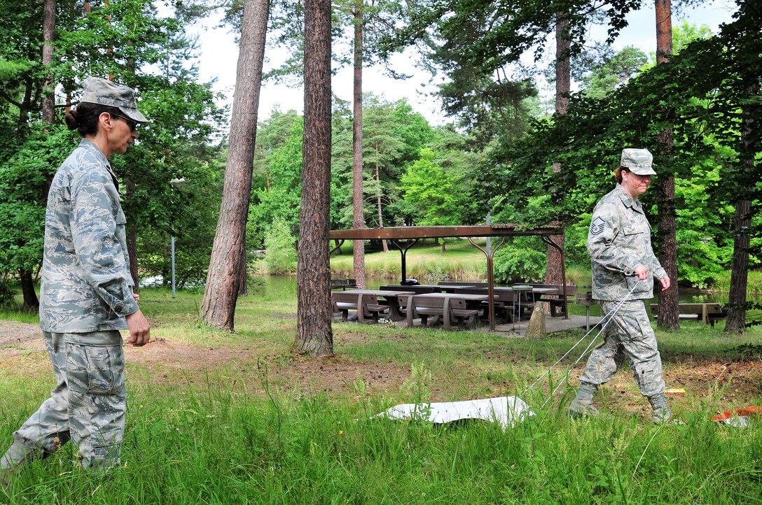 Lt. Col. Stephanie Steve and Master Sgt. Brandy Bush, medical technicians with the 178th Wing, conduct a tick drag at Ramstein Air Base in Germany, July 13, 2016. Tick drags are a technique that public health specialists use to survey the insects in their local areas. (Ohio Air National Guard photo by Airman 1st Class Rachel Simones)