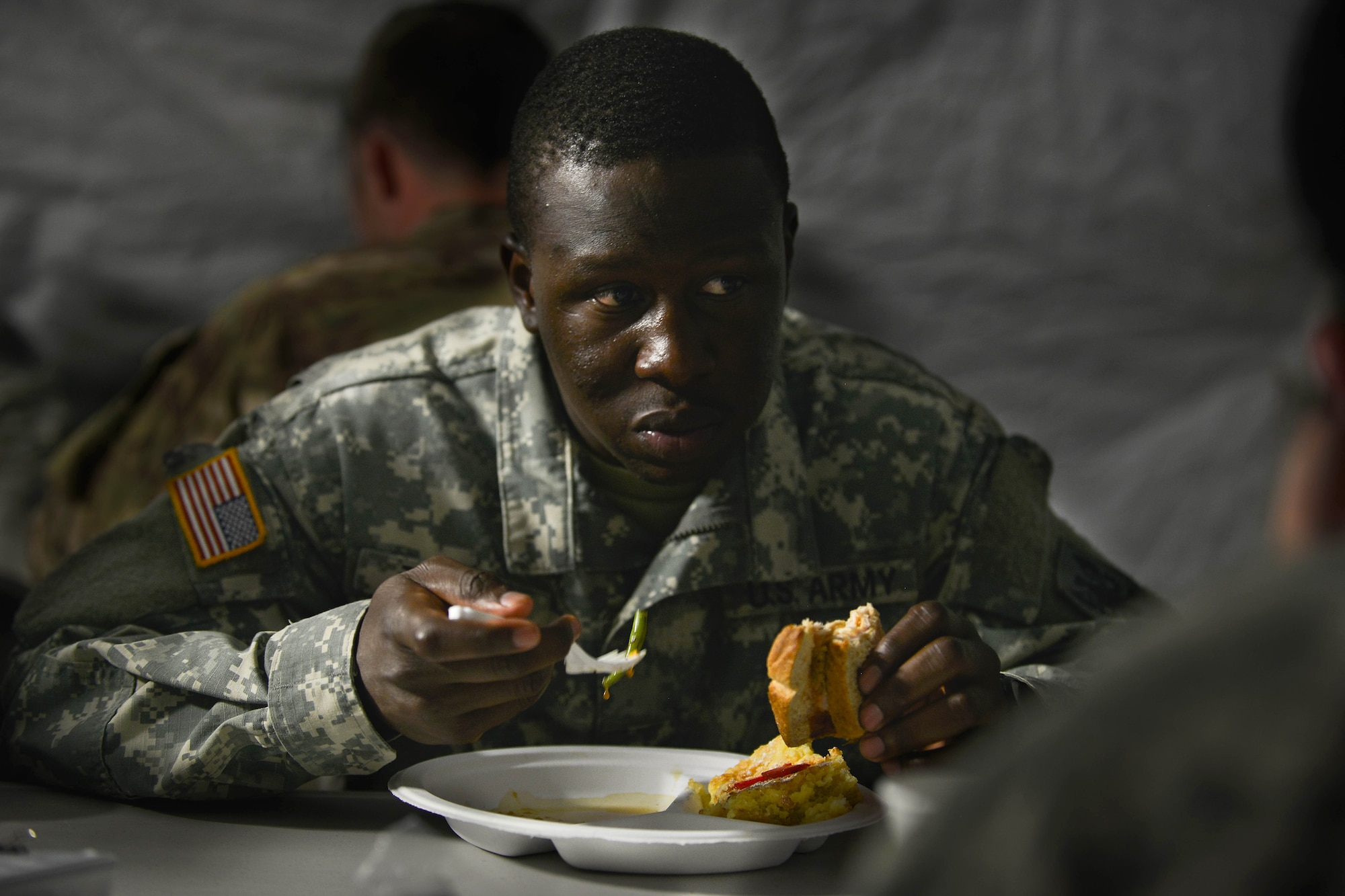 U.S. Army Pvt. Alfred Thomas, Echo Company, 5th Battalion, 159th General Support Aviation Brigade chemical equipment mechanic, enjoys a meal prepared by the 159th Avn. General Support Bde. cooks at Fort Eustis, Va., July 13, 2016.  The brigade prepared and served the meal as a practice-run for an upcoming culinary competition. (U.S. Air Force photo by Staff Sgt. Natasha Stannard)

