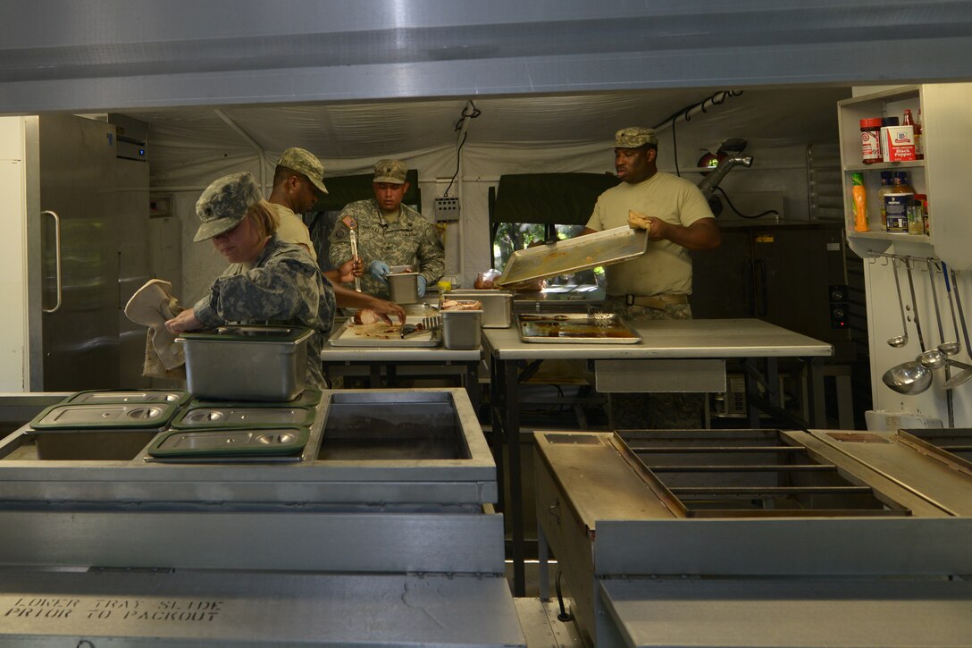 U.S. Army Reserve Soldiers with the Echo Company, 5th Battalion, 159th General Support Aviation Brigade, prepare a practice meal leading up to the Philip A. Connely Culinary Field Competition at Fort Eustis, Va., July 13, 2016.  The field meals are prepared in a containerized kitchen, which is a fully serviced mobile kitchen. (U.S. Air Force photo by Staff Sgt. Natasha Stannard)