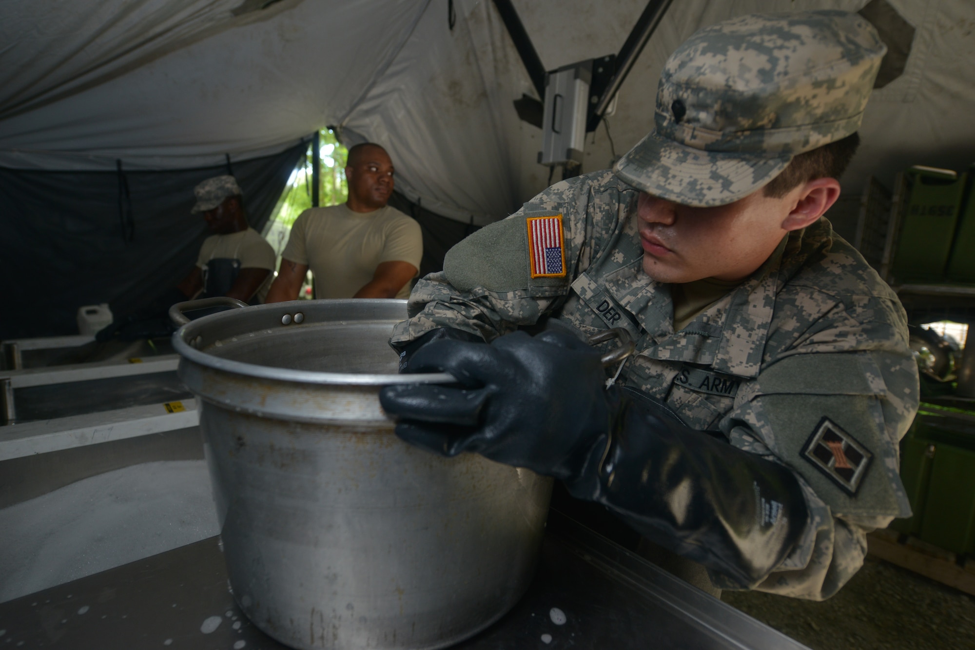 U.S. Army Reserve Soldiers with the Echo Company, 5th Battalion, 159th General Support Aviation Brigade clean dishes during a training in preparation for the Philip A. Connely Culinary Field Competition at Fort Eustis, Va., July 13, 2016.  The competition participants are evaluated on the field site layout, meal production, manpower use, meal taste and plating, as well as general operations. (U.S. Air Force photo by Staff Sgt. Natasha Stannard)