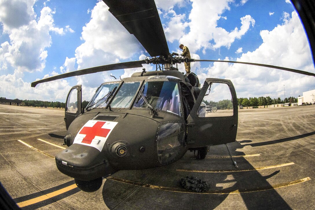 Army Capt. Daniel Prial inspects a UH-60 Black Hawk helicopter’s rotary blades before participating in a routine flight over Fort Bragg, N.C., July 12, 2016. Prial is a pilot assigned to the 3rd General Support Aviation Battalion. Army photo by Capt. Adan Cazarez