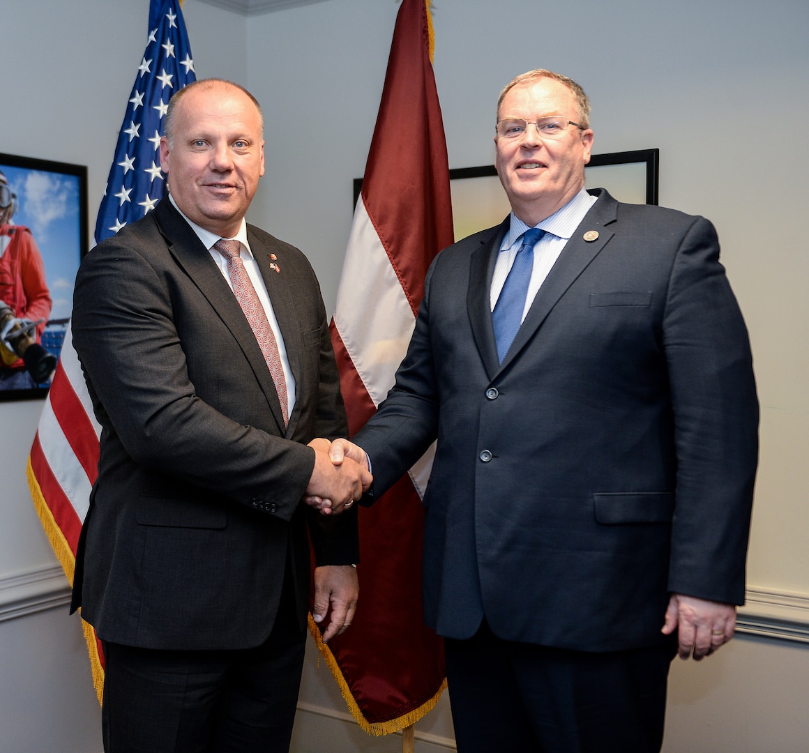 Deputy Defense Secretary Bob Work, right, greets Latvian Defense Minister Raimond Bergmanis to the Pentagon, July 19, 2016. DoD photo by Army Sgt. First Class Clydell Kinchen 