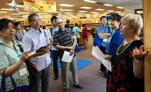 Belinda Pugh, 18th Force Support Squadron resource librarian, explains a display during a tour of the library to local Okinawan librarians July 13, 2016, at Kadena Air Base, Japan. The purpose of the tour was for local Okinawan librarians to familiarize themselves with American culture so they can set up an “American corner” in their libraries. (U.S. Air Force photo by Airman 1st Class Corey M. Pettis)