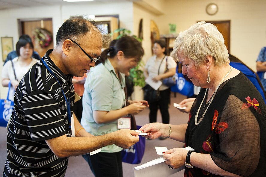 Belinda Pugh, 18th Force Support Squadron resource librarian, exchanges business cards with local Okinawan librarians July 13, 2016, at Kadena Air Base, Japan. Some Okinawan libraries are setting up an “American corner” in their libraries and wanted to experience first-hand the culture of an American library. (U.S. Air Force photo by Airman 1st Class Corey M. Pettis)