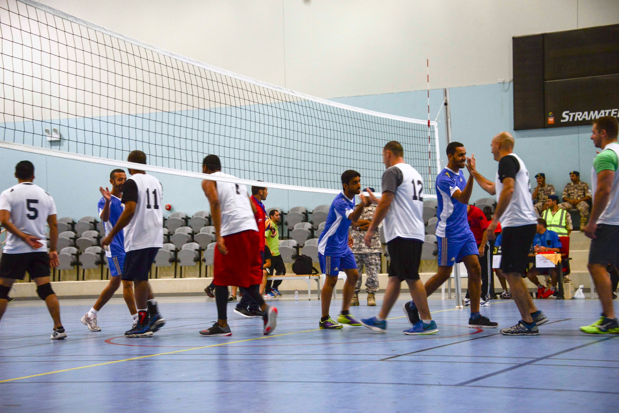 Members of Al Udeid Air Base and Qatar Emiri Air Force greet each other prior to a volleyball tournament June 2, 2016, at Al Udeid Air Base, Qatar. The QEAF hosted the volleyball match and followed it with a breakfast to help strengthen the partnership and build friendships between the U.S. and Qatari military. The match allowed the players to learn more about each other personally and culturally. (U.S. Air Force photo/Senior Airman Janelle Patiño/Released)