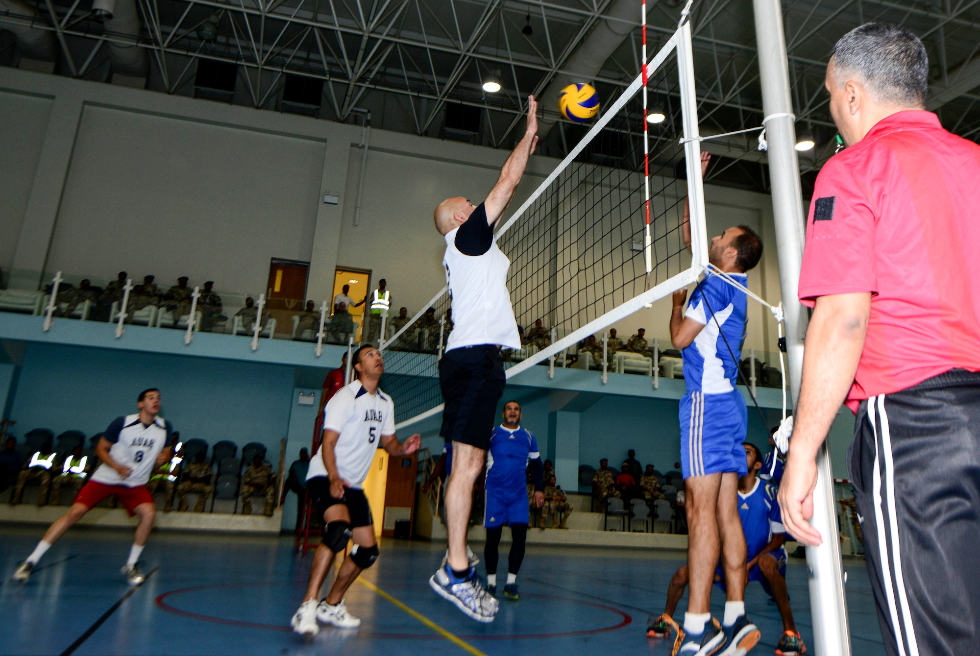 Maj. Matthew Bailey, 8th Expeditionary Air Mobility Squadron aerial port flight commander, blocks the ball during a volleyball tournament June 2, 2016, at Al Udeid Air Base, Qatar. The Qatar Emiri Air Force hosted a match for their squadrons, AUAB Airmen and Camp As Sayliyah personnel to strengthen the partnership and build friendships between the service members. (U.S. Air Force photo/Senior Airman Janelle Patiño/Released)