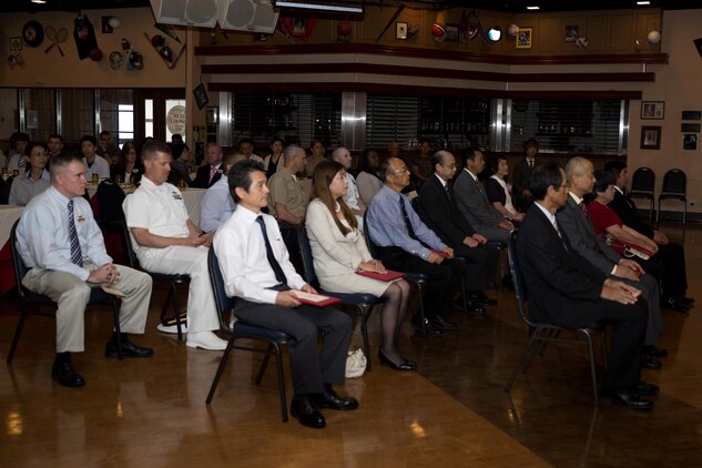 Master Contract Labor and Indirect Hire Agreement employees at the Landing Zone inside Club Iwakuni at Marine Corps Air Station Iwakuni, Japan, await the presentation of their awards July 15, 2016. A retirement ceremony was held in honor of the MLC and IHA employees’ hard work over the years. (U.S. Marine Corps photo by Lance Cpl. Joseph Abrego)