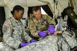 New York Army National Guard 1st Lt. Mercy Ukpe and Sgt. Shawn Wilson, assigned to Headquarters Co., 1st Battalion, 69th Infantry assess a Soldier for medical care during a mass casualty exercise at the Army’s Joint Readiness Training Center, Fort Polk, La., Saturday, July 16, 2016. More than 3,000 New York Army National Guard Soldiers deployed for a three week exercise at the Army’s Joint Readiness Training Center, July 9-30, 2016.
