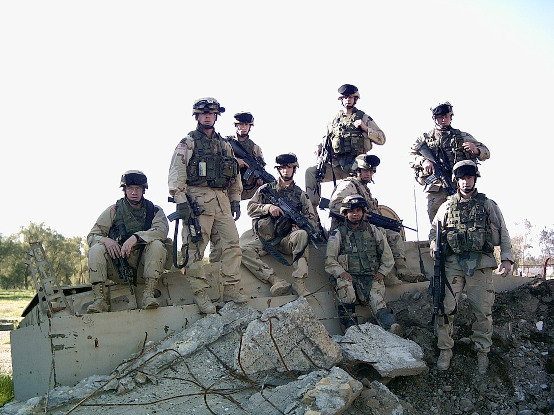 Retired Army Staff Sgt. Mitch Court (second from left) stands among his squad in Afghanistan in 2009 the day before he was severely injured in combat. Court's recovery included major surgeries to his legs, face, lung and ribs. He is now a quality assurance specialist with Defense Contract Management Agency Cleveland.