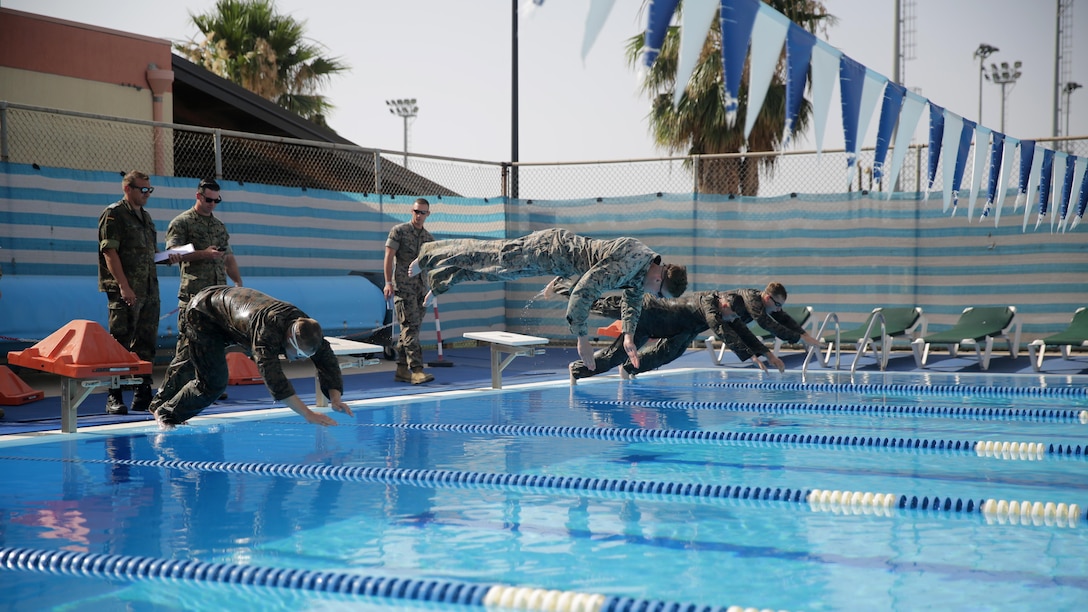 Marines with Special Purpose Marine Air-Ground Task Force Crisis Response-Africa, dive into the pool for a 100-meter timed swim during a fitness test for the German Armed Forces Badge for Military Proficiency at Naval Air Station Sigonella, Italy, July 6, 2016.  Marines with 1st Battalion, 8th Marine Regiment completed the test and earned the decoration of the Bundeswehr, the armed forces of the Federal Republic of Germany.