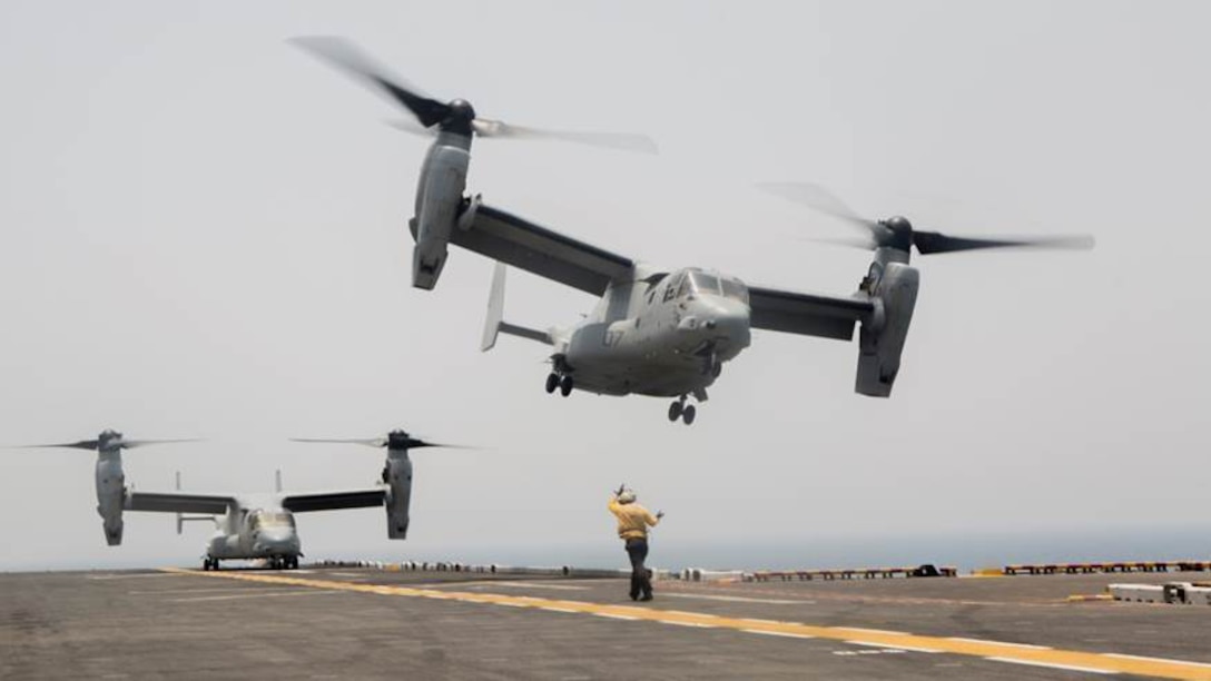 An aviation boatswain’s mate guides an MV-22 Osprey from VMM-363, Special Purpose Marine Air Ground Task Force-Crisis Response-Central Command, to land on the deck of the amphibious assault ship USS Boxer, July 7, 2016. The 13th Marine Expeditionary Unit hosted flight deck landing qualifications for SPMAGTF-CR-CC MV-22's, demonstrating interoperability between Navy and Marine Corps units . The Boxer is currently in support of the 13th Marine Expeditionary Unit operating in and around the Central Command area of responsibility.  SPMAGTF-CR-CC is forward deployed in several host nations, with the ability to respond, rapidly, to a variety of contingencies.