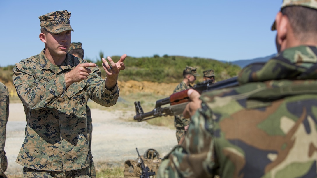 U.S. Marine Corps Sgt. Caleb R. Kinnaird, a rifleman with Black Sea Rotational Force, gives assistance to a Bulgarian soldier about how to properly search, scan and assess after a speed reload drill during Exercise Platinum Lion 16-4 at Novo Selo Training Area, Bulgaria, July 12, 2016. This multi-national exercise brings together eight NATO and partner nations for a live-fire exercise aimed to strengthen regional defense in Eastern Europe.