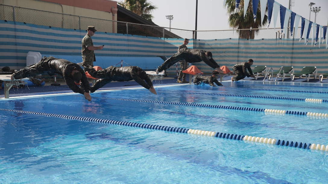 Marines with Special Purpose Marine Air-Ground Task Force Crisis Response-Africa, dive into the pool for a 100-meter timed swim during a fitness test for the German Armed Forces Badge for Military Proficiency at Naval Air Station Sigonella, Italy, July 6, 2016.  Marines with 1st Battalion, 8th Marine Regiment completed the test and earned the decoration of the Bundeswehr, the armed forces of the Federal Republic of Germany.