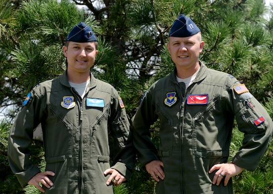 U.S. Air Force Capt. Justin Kellett, C-5 Galaxy pilot and U.S. Air Force Capt. Kyle Kellett, C-17 Globemaster III pilot, pose for a photo, July 12, 2016 at Altus Air Force Base. Close in age, the brothers have spend their entire lives in similar paths of life and now find themselves temporarily at Altus Air Force Base together.(U.S. Air Force Photo by Airman Jackson N. Haddon/Released).
