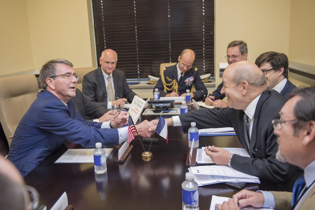 Defense Secretary Ash Carter, left, shakes hands with French Defense Minister Jean-Yves Le Drian at a meeting of defense ministers and senior leaders from the coalition to counter the Islamic State of Iraq and the Levant at Joint Base Andrews, Md., July 20, 2016. DoD photo by Air Force Tech. Sgt. Brigitte N. Brantley