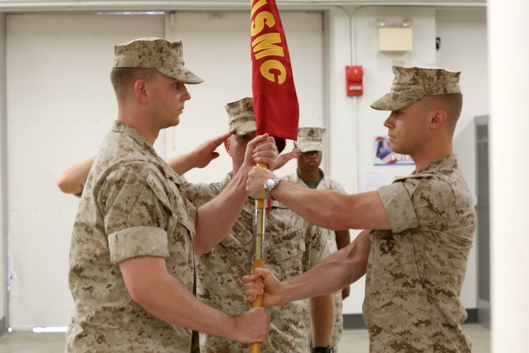 NAVAL SUPPORT FACILITY INDIAN HEAD, MD. -- Capt. Lucas H. Forcella (right) passes the Headquarters and Service Company guidon to Capt. Robert G. Ukrainec during a change of command ceremony at Naval Support Facility Indian Head, Md., July 13, 2016. This Marine Corps drill movement symbolizes the passing of authority from outgoing to incoming company commander. (Official USMC Photo by Sgt. Jonathan S. Herrera/Released)