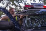 Maj. Jason Powell, 12th Flying Training Wing chief of flight safety, aims an air pellet rifle at a white-winged dove July 13, 2016 on Joint Base San Antonio-Randolph. The air pellet rifle is similar to a BB gun, but it uses tank-compressed air and non-lead pellets instead of pumped air and BBs. 