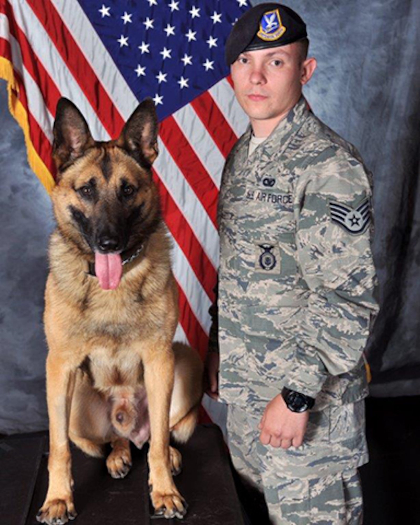 U.S. Air Force Staff Sgt. Tyler Sexton, 23d Security Forces Squadron military working dog handler, poses for an official photo with his partner, MWD Nido. Sexton and Nido share a close bond, allowing the team to pass certifications in only 8 days, a task that can take up to 90 days for less compatible teams. Their connection will play an important role as they deploy to Southwest Asia for a base security operations mission. (U.S. Air Force courtesy photo)