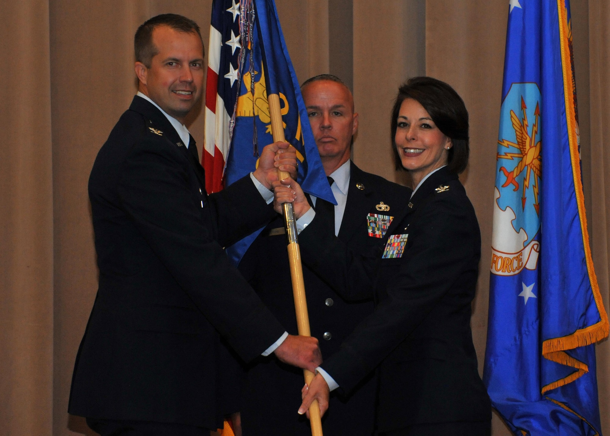 Col. DeDe Halfhill accepts command of the 2nd Mission Support Group from Col. Ty Neuman, 2nd Bomb Wing commander, during a change of command ceremony at Barksdale Air Force Base, La., July 19, 2016. Halfhill comes to the position after serving as director of Public Affairs for Air Mobility Command at Scott Air Force Base, Ill. (U.S. Air Force photo/Senior Airman Joseph Raatz)