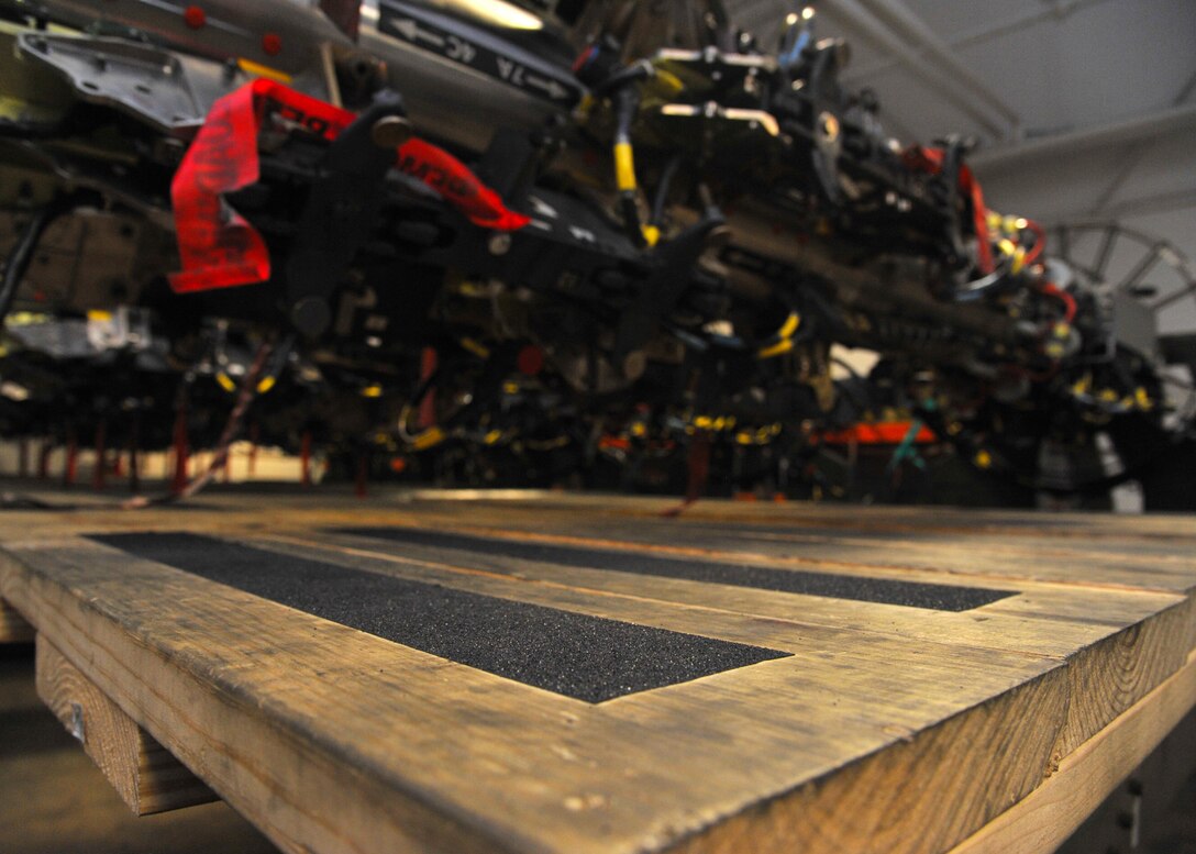 A wooden platform rests beneath a Common Rotary Launcher at Barksdale Air Force Base, La., July 12, 2016. The $35 platform, created by Staff Sgt. Daniel Babis, 2nd Munitions Squadron armament team chief, is a marked improvement over the inefficient and hazardous step stools that were used previously by armaments Airmen. (U.S. Air Force photo/Senior Airman Joseph Raatz)