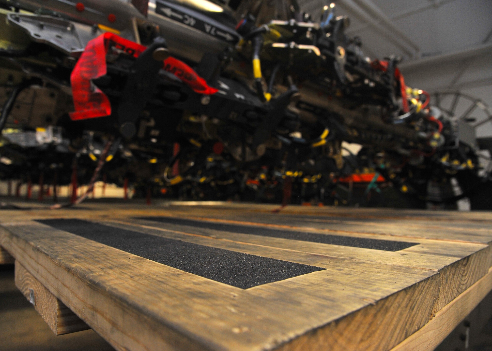 A wooden platform rests beneath a Common Rotary Launcher at Barksdale Air Force Base, La., July 12, 2016. The $35 platform, created by Staff Sgt. Daniel Babis, 2nd Munitions Squadron armament team chief, is a marked improvement over the inefficient and hazardous step stools that were used previously by armaments Airmen. (U.S. Air Force photo/Senior Airman Joseph Raatz)