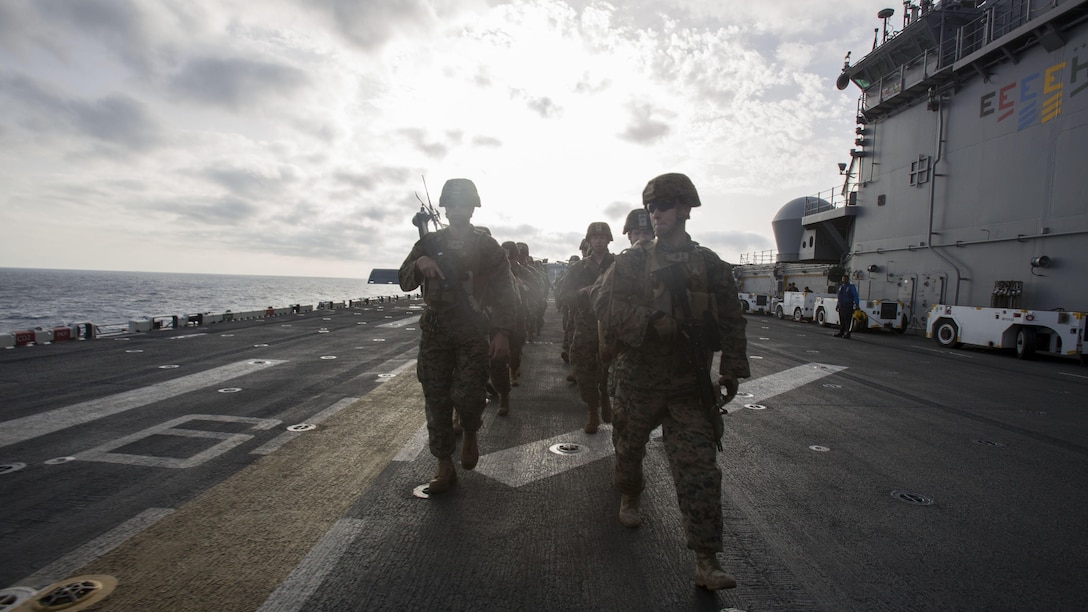 Marines assigned to Headquarters and Service Company, Battalion Landing Team, 1st Battalion, 6th Marine Regiment, 22nd Marine Expeditionary Unit, hike aboard the amphibious assault ship USS Wasp July 18, 2016. 22nd MEU, deployed with the Wasp Amphibious Ready Group, is conducting naval operations in the 6th Fleet area of operations in support of U.S. national security interests in Europe. 
