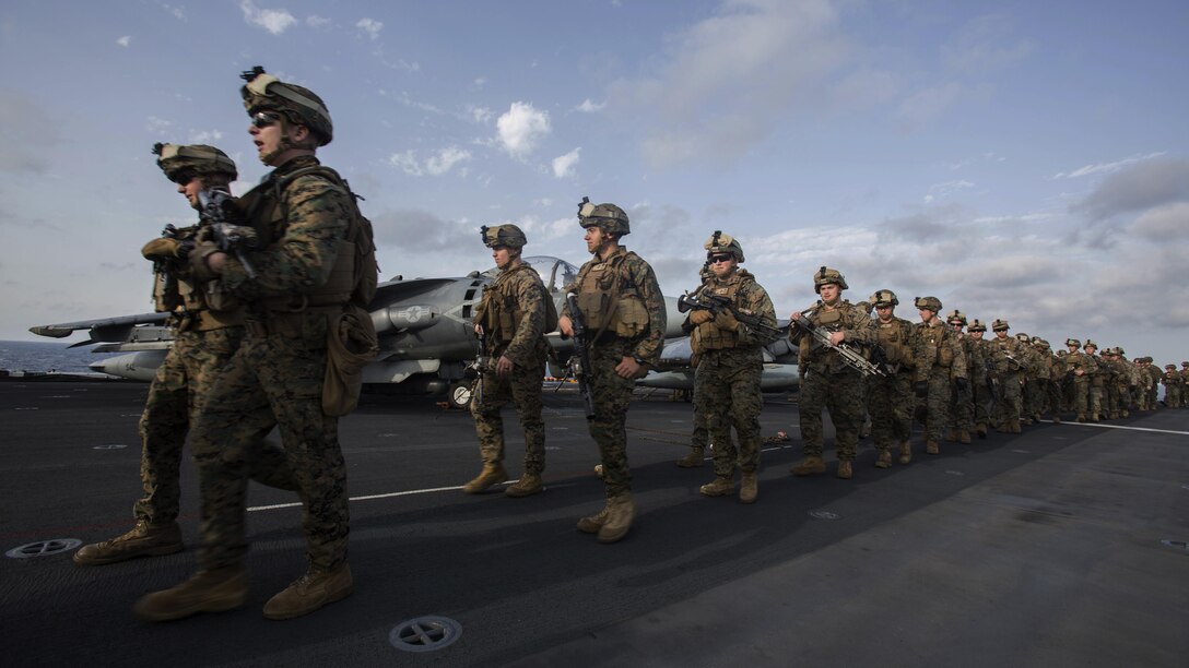Marines assigned to Headquarters and Service Company, Battalion Landing Team, 1st Battalion, 6th Marine Regiment, 22nd Marine Expeditionary Unit, hike aboard the amphibious assault ship USS Wasp, July 18, 2016. 22nd MEU, deployed with the Wasp Amphibious Ready Group, is conducting naval operations in the 6th Fleet area of operations in support of U.S. national security interests in Europe. 