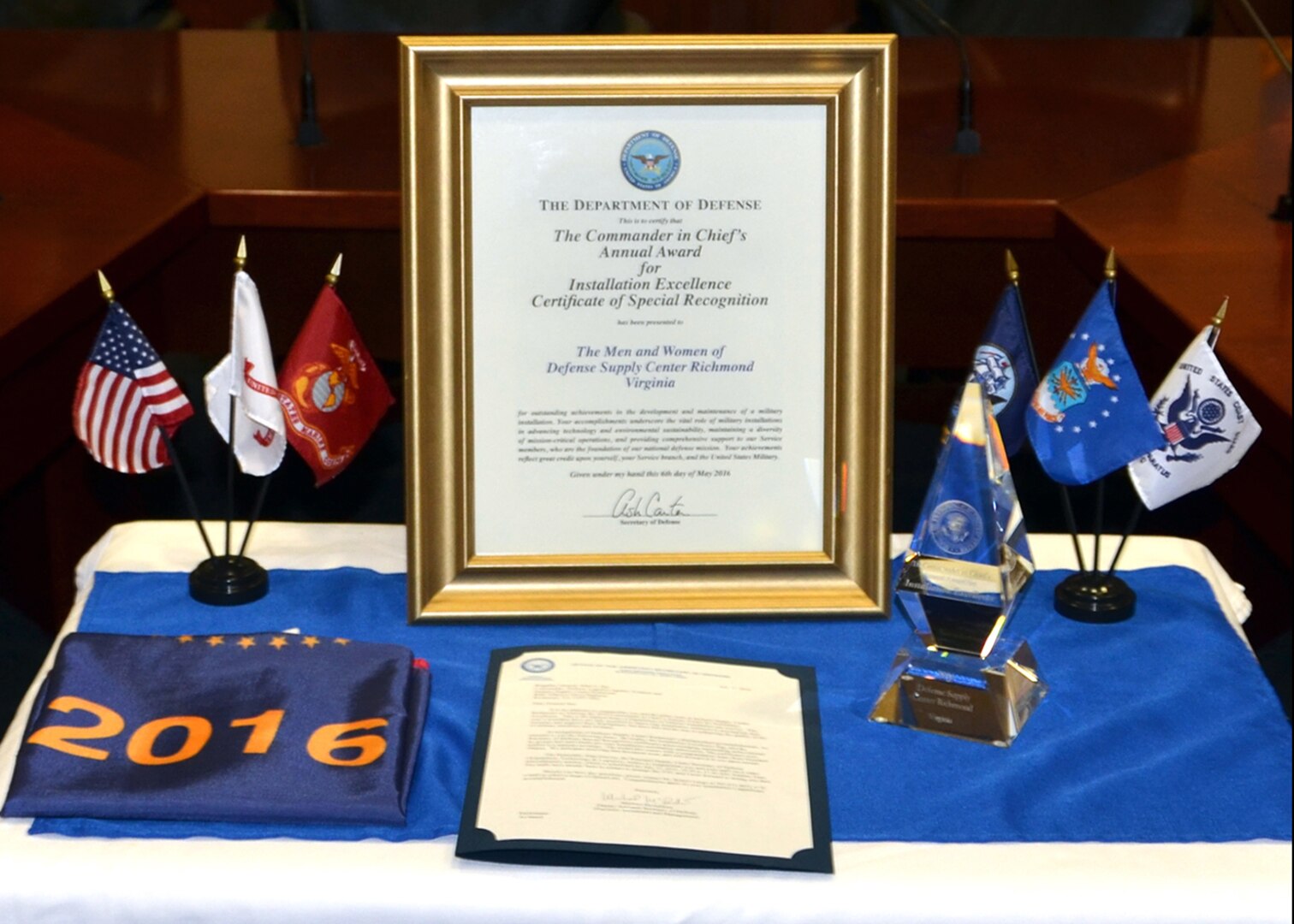 Following a July 15, 2016 video telecast ceremony, Defense Supply Center Richmond, Virginia, installation officials display awards received as a winner of the 2015 Commander in Chief's Annual Award for Installation Excellence. 