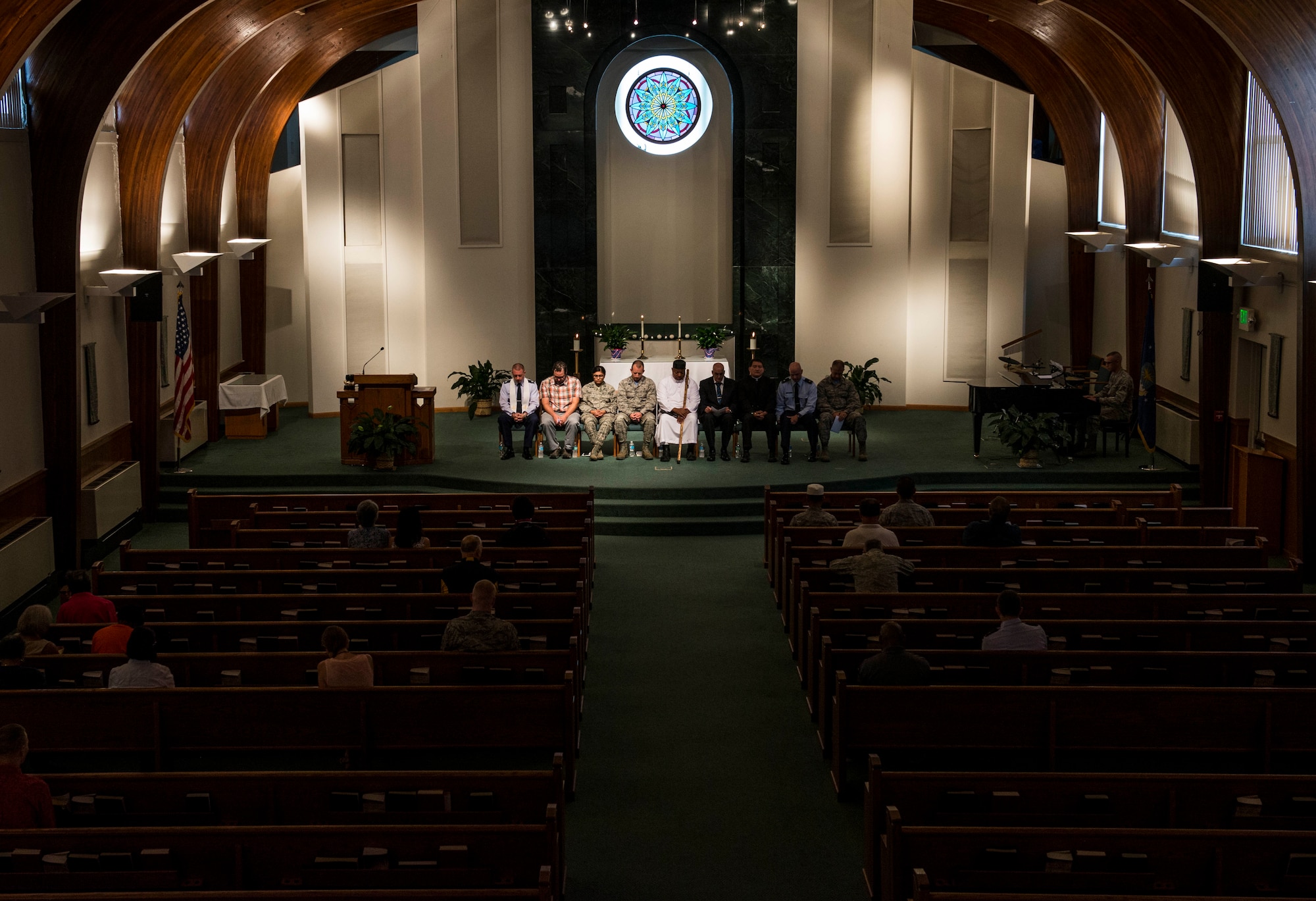 Chaplain (Capt.) Eli Dowell, and Tim Missi take a moment for personal prayer during an interfaith prayer service, Scott Air Force Base, July 15, 2016. The chapel held the prayer service in response to the shootings in Orlando, Falcon Heights, Baton Rouge, Dallas, and the attack that killed 84 in Nice, France.   The service included representatives from at least six religions, including the Hindu, Protestant, Islamic, Soka Gakkai International Buddhist, Catholic, and Greek Orthodox faiths.  (U.S. Air Force photo by Staff Sgt. Jodi Martinez/Released)
