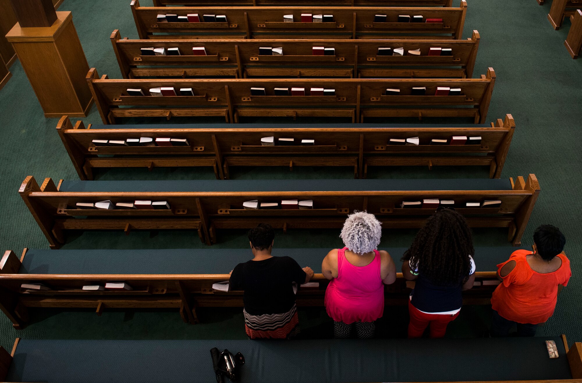 Attendees take a moment of prayer during an interfaith prayer service, Scott Air Force Base, July 15, 2016. The Scott Air Force Base chapel held the prayer service in response to the shootings in Orlando, Falcon Heights, Baton Rouge, Dallas, and the attack that killed 84 in Nice, France.   The service included representatives from at least six religions, including the Hindu, Protestant, Islamic, Soka Gakkai International Buddhist, Catholic, and Greek Orthodox faiths.  (U.S. Air Force photo by Staff Sgt. Jodi Martinez/Released)