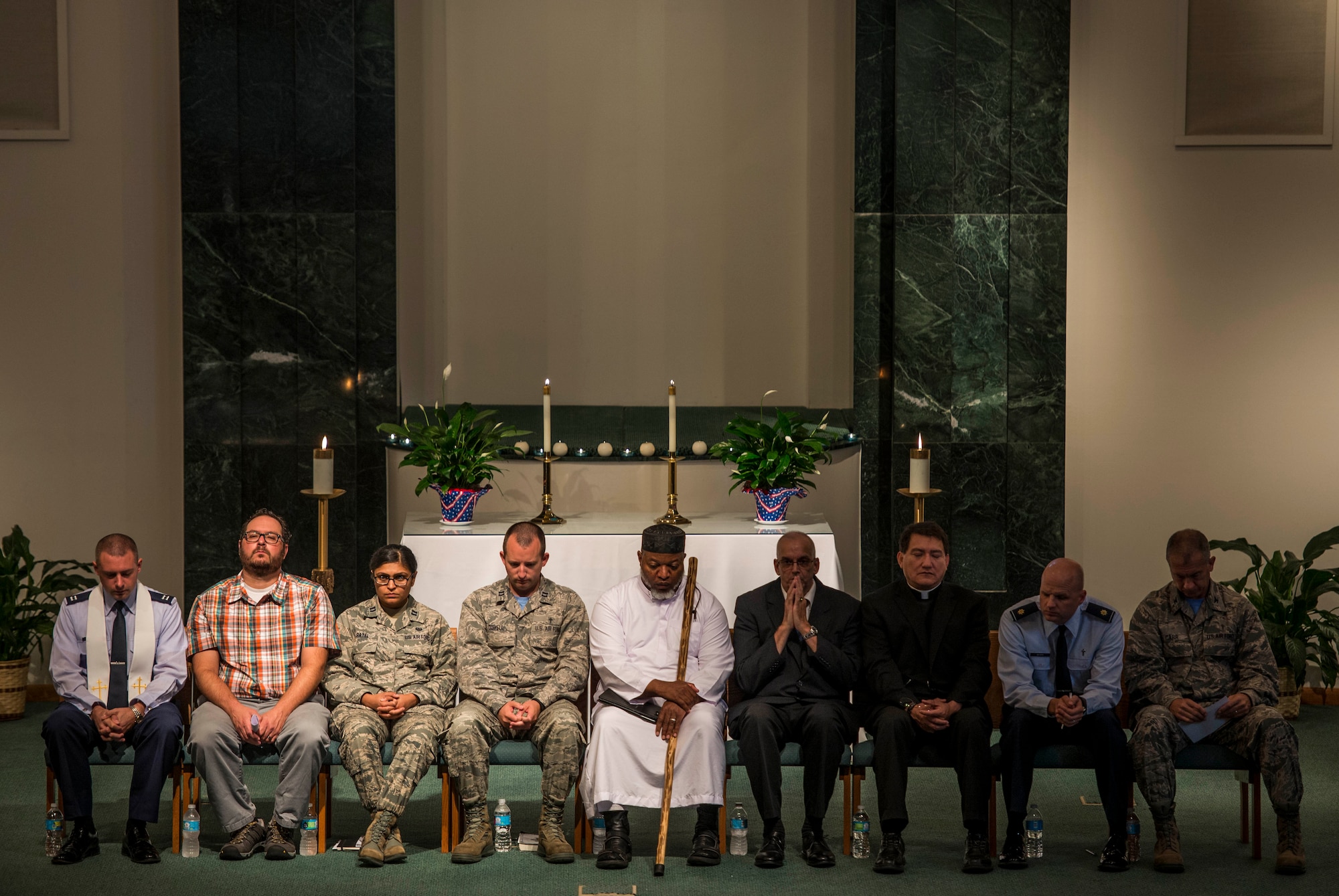 Representatives from multiple religions pray during an interfaith prayer service, Scott Air Force Base, July 15, 2016. The chapel held the prayer service in response to the shootings in Orlando, Falcon Heights, Baton Rouge, Dallas, and the attack that killed 84 in Nice, France.   The service included representatives from at least six religions, including the Hindu, Protestant, Islamic, Soka Gakkai International Buddhist, Catholic, and Greek Orthodox faiths.  (U.S. Air Force photo by Staff Sgt. Jodi Martinez/Released)
